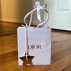 Dior small white shopping bag with gold star charm and ribbon